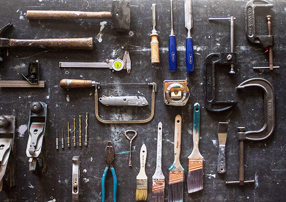 A bunch of tools are on the wall